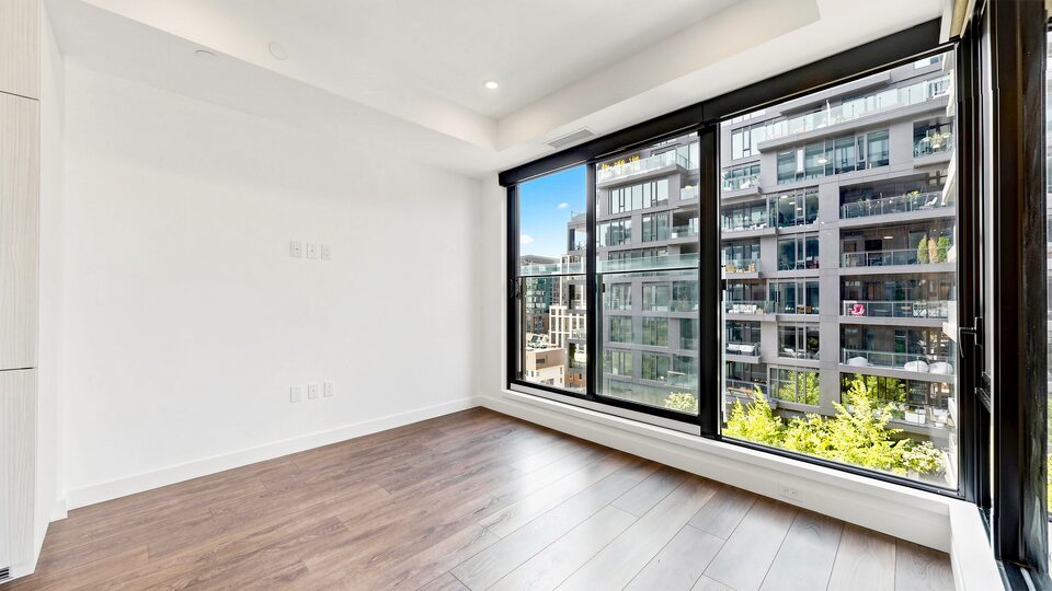 Living room with floor-to-ceiling windows overlooking the courtyard